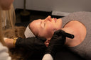 Woman receiving microneedling facial with exosomes at a clinical skincare studio in Vancouver